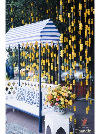 A classic Haldi setup with a twist. We combined traditional marigolds with a blue and white striped canopy and blue pottery-inspired cushions, giving the space a fresh, summery, and distinctly Jaipur feel.