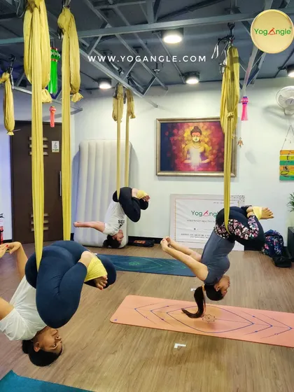 This is what a typical class looks like, a space filled with focused energy. I guide each student personally, ensuring everyone, from beginners to advanced practitioners, can safely explore inversions, stretches, and flows at their own pace.