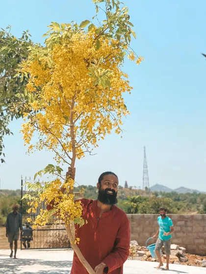 This is a duplicate of image 82. It shows me with a flowering tree, symbolizing the beauty and growth that our connection with nature brings.