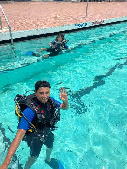 A happy student during a confined water training session. Mastering skills in the pool builds the confidence you need for your first ocean dive.