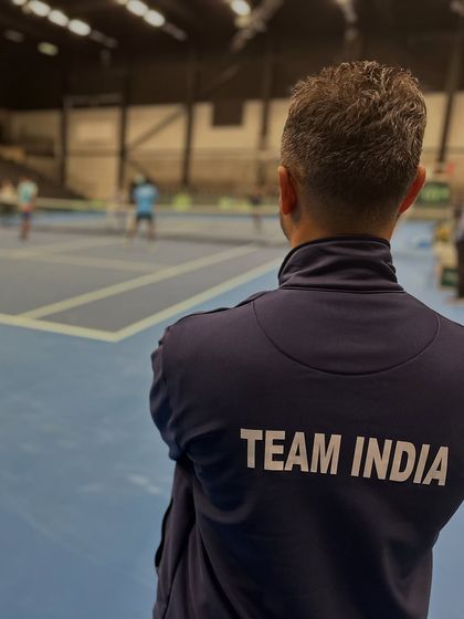 A moment of focus, watching our players from the sidelines. Wearing the 'Team India' jacket is a constant reminder of the responsibility I have to keep our national athletes in peak condition.