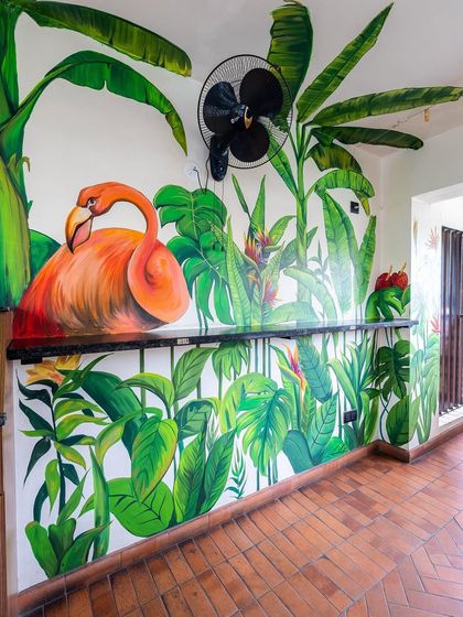 Another view of the flamingo mural, showing how it wraps around the space and integrates with the bar counter.