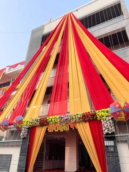 A closer look at the wedding house entrance, showing the floral arrangement and the "Shadi Wala Ghar" sign.