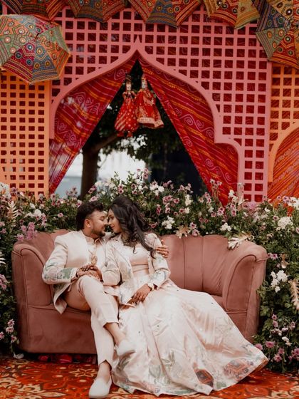 An intimate moment for the couple on the Sangeet stage, surrounded by flowers.