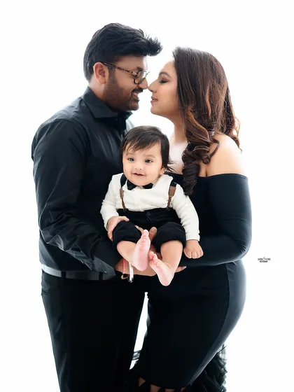 A romantic and sweet family photo against a clean white background.