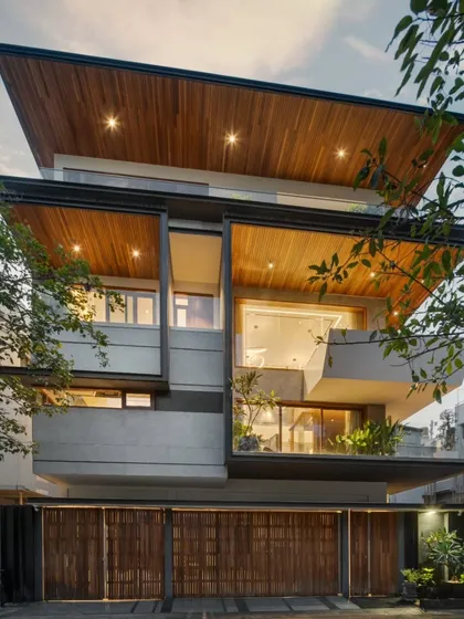 The Timber Edge project showcases our approach to architectural intervention. As dusk settles, the home's layered facade comes alive, with warm light accentuating the interplay between timber cladding, concrete forms, and deep-set balconies that engage with the streetscape.