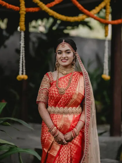 A classic bridal portrait of Tanu, showcasing her complete look from head to toe.