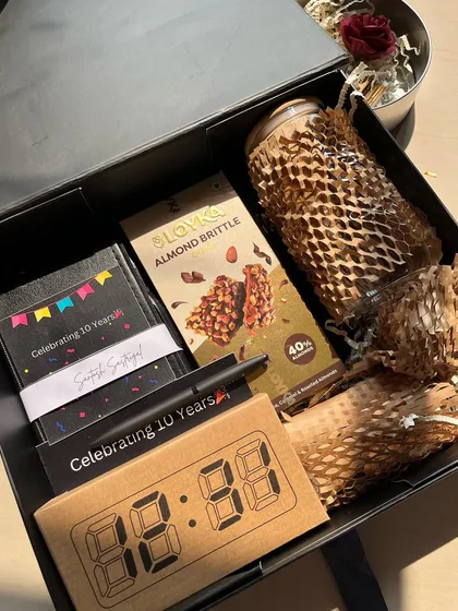 A bespoke 10th-anniversary hamper for Bloomberg. This gift box is filled with 10 unique items, including a digital clock and custom notepad, to celebrate a decade of excellence.
