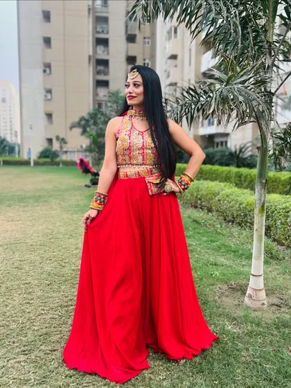 Dressed in a festive red outfit for a celebration. I believe that the right costume is essential to a performance, and I help coordinate looks for my entire troupe to fit the event's theme.