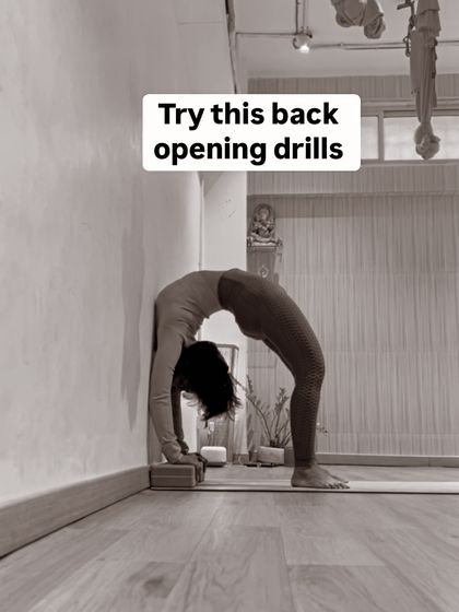 Try these back-opening drills. This black and white image shows me using blocks for support in a deep wheel pose, which is a great way to modify the pose.