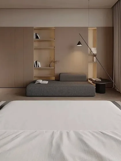The other side of the room, showing the built-in shelving and a comfortable daybed for reading or relaxing.