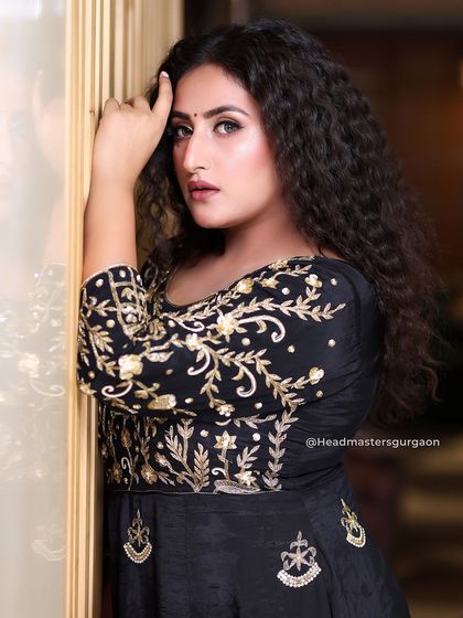 This pose captures the attitude of the entire look. The wild curls and confident makeup come together to create a truly memorable style.