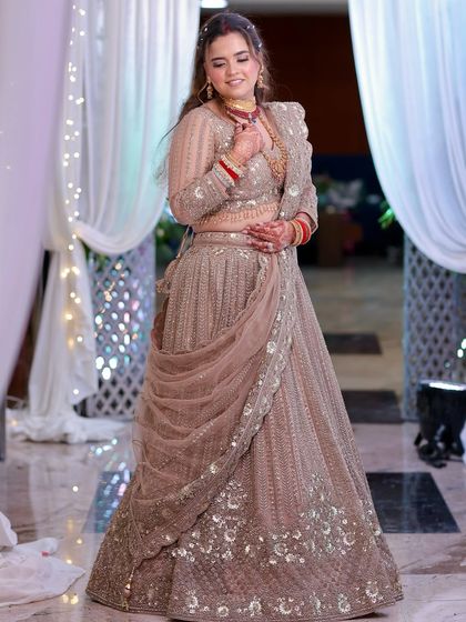 Vidushi looking absolutely regal in her engagement attire. The draping of the dupatta and the soft makeup create a very elegant silhouette.