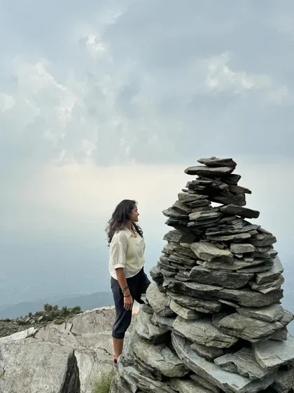A moment of quiet contemplation by a stack of stones on the Triund trek. The mountains have a way of putting everything into perspective.