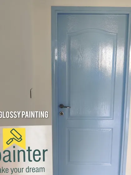 An interior door gets a modern update with a flawless coat of light blue glossy paint. Our wood painting service can completely change the feel of a room, providing a clean and vibrant finish.