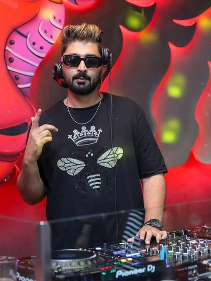 Posing with a fan at the DJ booth on a Sunday night.