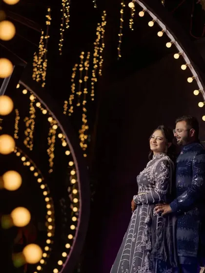 I love using creative lighting to make couple portraits that stand out. For this shot at the Shrusti Farmhouse in Panvel, we used the venue's decorative lights to create a beautiful, romantic frame around the couple, making for a memorable reception photo.