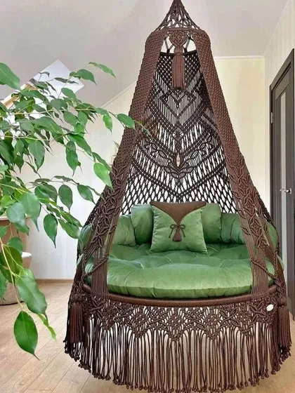 This dark brown swing with a green mattress is perfect for a room with natural elements. The tassels on the side are a classic boho detail.