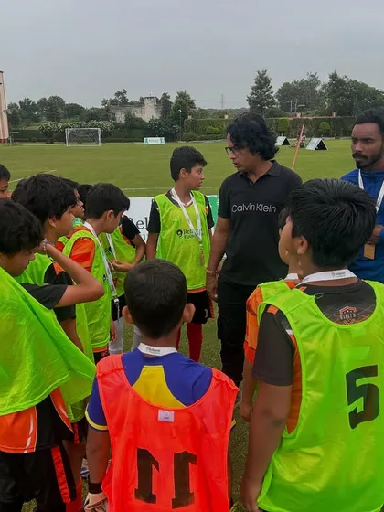 Strategy before the storm. A coach delivers a pre-match talk, a crucial part of our training where we discuss tactics, roles, and motivation to ensure our players are mentally prepared for the game ahead.