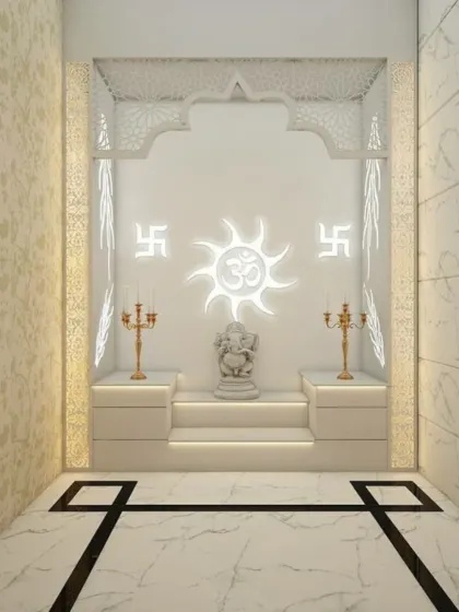 A pristine and peaceful pooja room designed in all-white with clean, geometric lines. The central focus is a backlit panel with Om and Swastik symbols, creating a serene glow around the Ganesha idol placed on a stepped platform.
