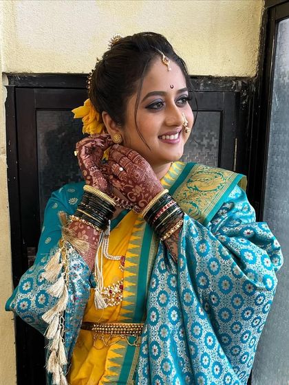 A natural and subtle airbrush makeup look for Sneha's big day. The yellow and blue saree combination is vibrant and beautiful.