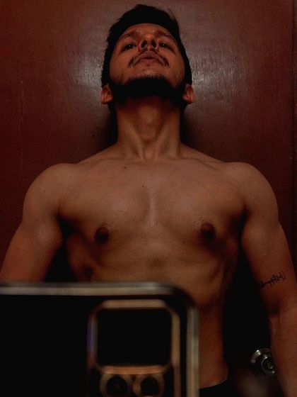 A post-workout selfie showing chest and shoulder definition. This is what a consistent push-day routine can build.