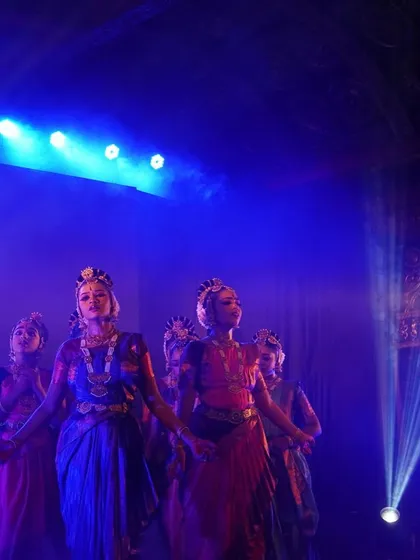 A group of our dancers performing at the Udupi Sri Krishna Matha. The stage lighting and grand setting add to the divine atmosphere of our "KRISHNA" production.