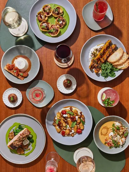 A feast for the eyes. An overhead shot of a table filled with a variety of our dishes and drinks, ready for a celebration.