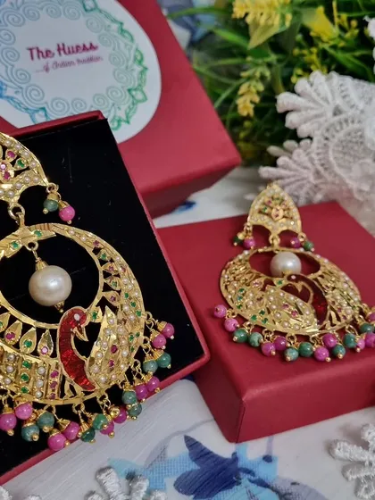 Meet my मोर चंदबाली (Peacock Chandbali). These gold-plated Jadau earrings feature a detailed peacock motif with colourful stones, making them a true statement piece for any celebration.