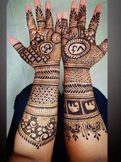 A reverse view of the 'VJ' engagement mehandi, showing the design from the forearm perspective.