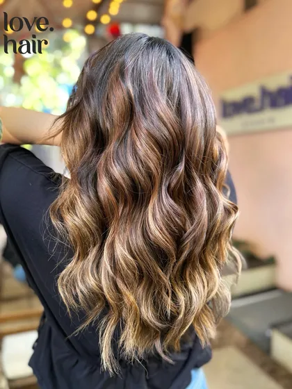 A detailed shot of the sun-kissed balayage, showing the placement of the lighter pieces.