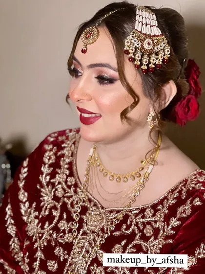 Another beautiful shot of this happy bride. The side-swept curls and red roses in her hair add a touch of romantic elegance.