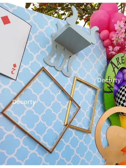 A close-up of the whimsical decor elements, including floating frames and playing cards.
