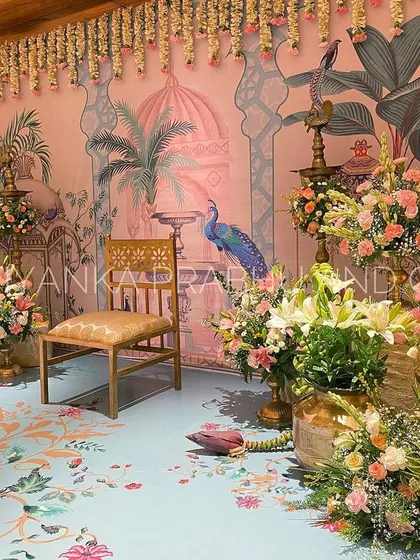 I adore bringing unique artistic visions to life, like this Pichwai-inspired backdrop for a pre-wedding celebration. The hand-painted details, combined with fresh flowers, banana plants, and traditional brass lamps (kuthu vilakku), create an elegant and culturally rich setting.