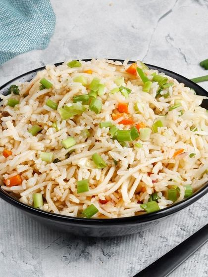 Our Vegetable Fried Rice, a simple and comforting dish. It's stir-fried with fresh carrots and spring onions to complement any of our main dishes.