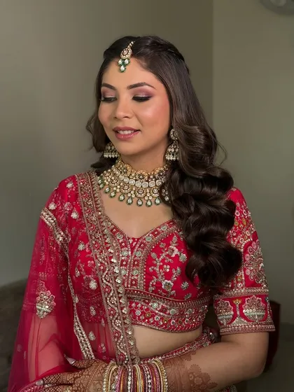 A side profile showcasing the soft waves in her hair and the perfectly blended makeup. This look is all about timeless elegance for the modern bride.