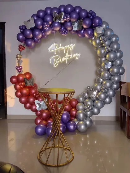 A stylish balloon ring with a unique color combination of red, purple, and silver. Butterfly accents are added for a whimsical touch.