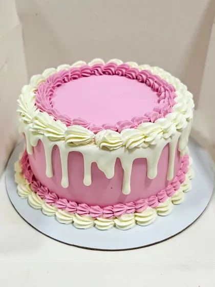 The buttercream drip cake before the topper was added, showing the clean finish and piped details.