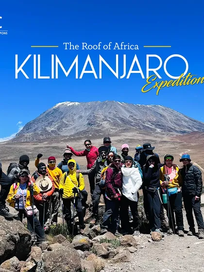 A team photo with Kilimanjaro, the roof of Africa, in the background. This non-technical climb is a perfect entry into the world of the Seven Summits.