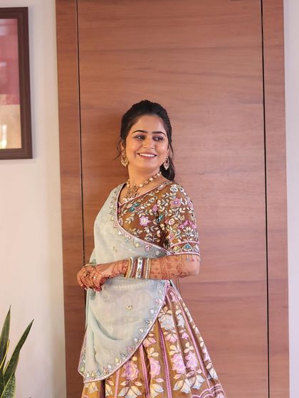 A happy and radiant client. Her makeup is soft and natural, allowing her beautiful smile and outfit to take center stage.