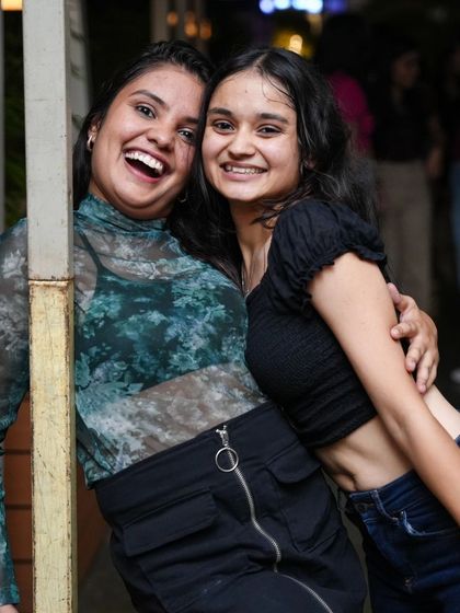 Two friends sharing a laugh at one of our weekend parties. We create a fun and welcoming atmosphere where you can make great memories.