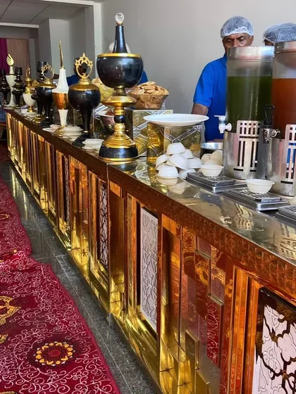 For grand weddings and corporate events, we bring out the best. This elegant golden buffet counter setup shows how we can scale our services for any event size without losing that personal touch.