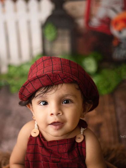 A heartbreaker in the making. This little man is looking right at the camera with his big, beautiful eyes in his cute rustic outfit.