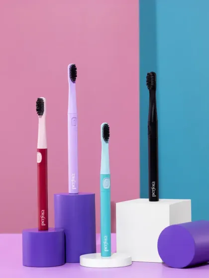 A clean and modern group shot for a range of electric toothbrushes. We used colorful geometric blocks and a split-tone background to create a playful yet organized composition, showcasing the different product colors for an e-commerce platform.