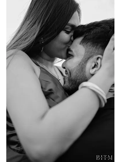 A tender black and white close-up of a kiss on the forehead. This intimate and emotional shot from the Goa series captures a moment of pure affection and care.