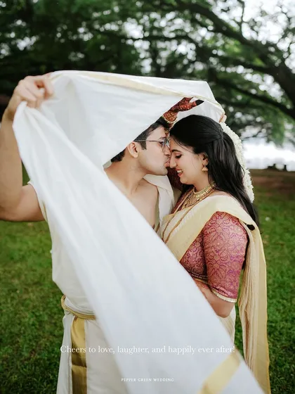 A romantic and intimate portrait of the couple under the groom's mundu, a classic and sweet shot.