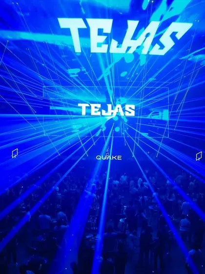 A stunning shot of the blue laser grid filling the entire space at Quake in Hyderabad, with my name on the screen.