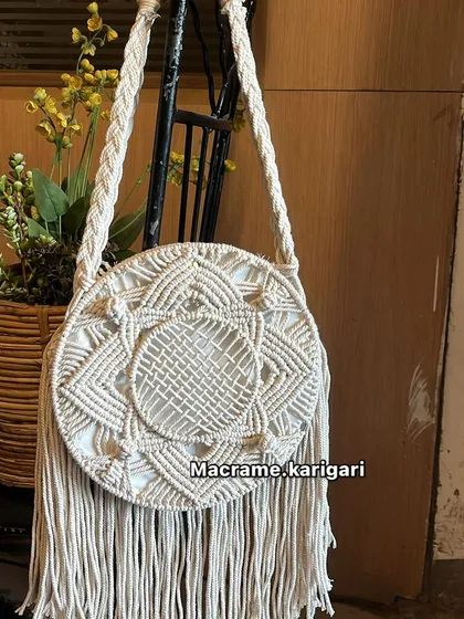 Our classic white round macramé bag. The clean color highlights the beautiful, handcrafted knotting patterns, making it an elegant and stylish choice.