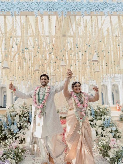 Pure happiness! The couple celebrates after their ceremony, surrounded by a pastel floral wonderland and a ceiling of delicate, hanging tuberoses.