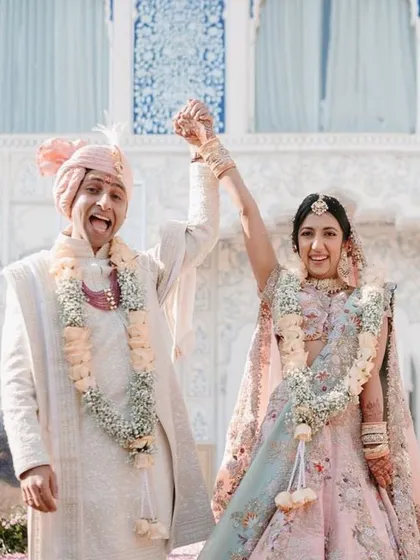A moment of pure joy and triumph. This is what a dream wedding looks like, where every detail comes together to celebrate your union against a backdrop of architectural splendor.